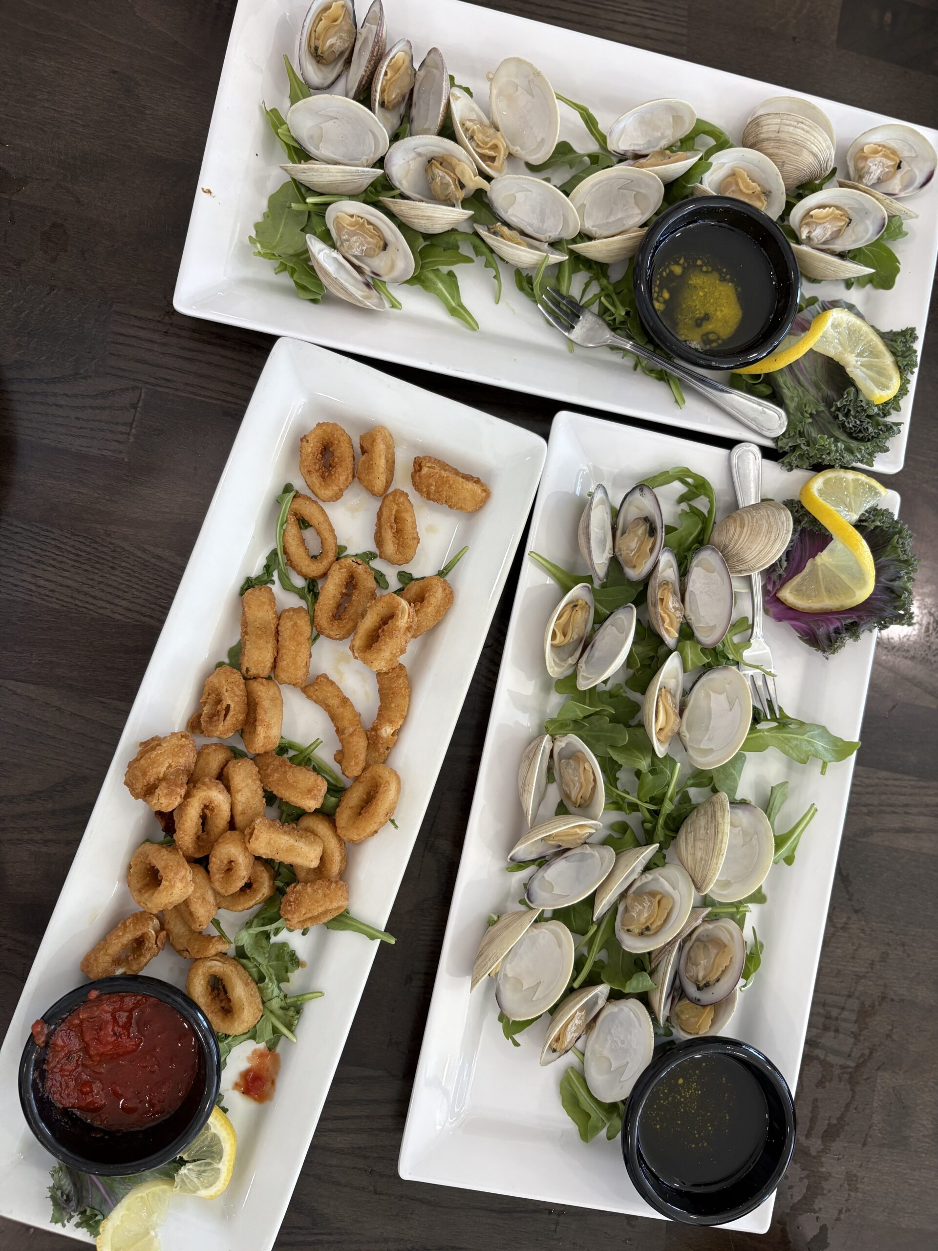 Seafood dishes arranged on a dining table from beachside restaurant.